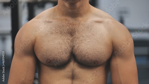 A man moves his strong and muscular chest photo