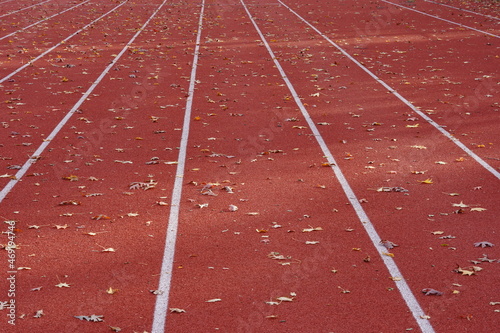 Track and Field running lanes full of leafs during autumn
