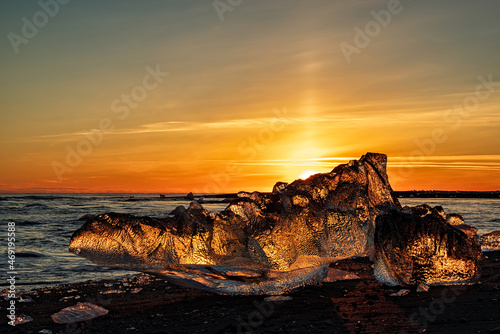 Icebergs in diamond beach in Vatnajokull National Park at sunset, Iceland photo