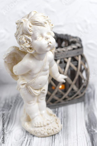 Vintage baby angel figurine. Little cupid statue. Interior statues for decorating the living room and home. Vertical orientation. © Настя ВольФ