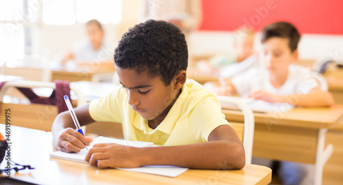 Fényképezés Portrait of an arab boy at school desk in a classroom
