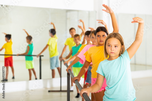 Children exercising ballet moves during their group training. © JackF