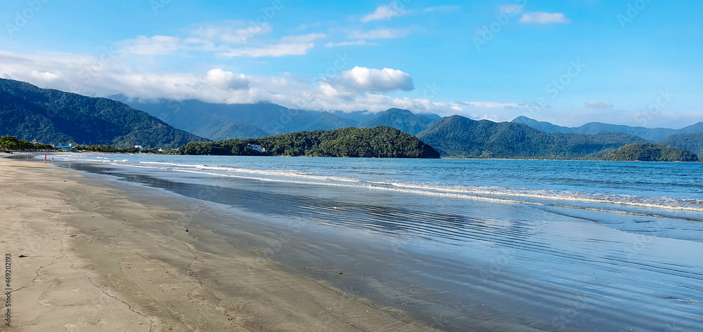 Tropical beach with dark sands due to oil