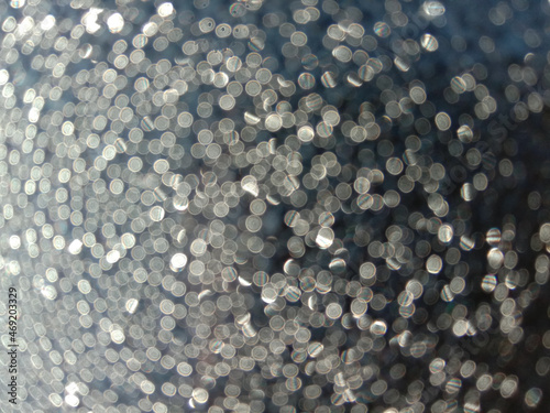 Shiny bokeh balls closeup, defocus photo of dew drops in sunlight