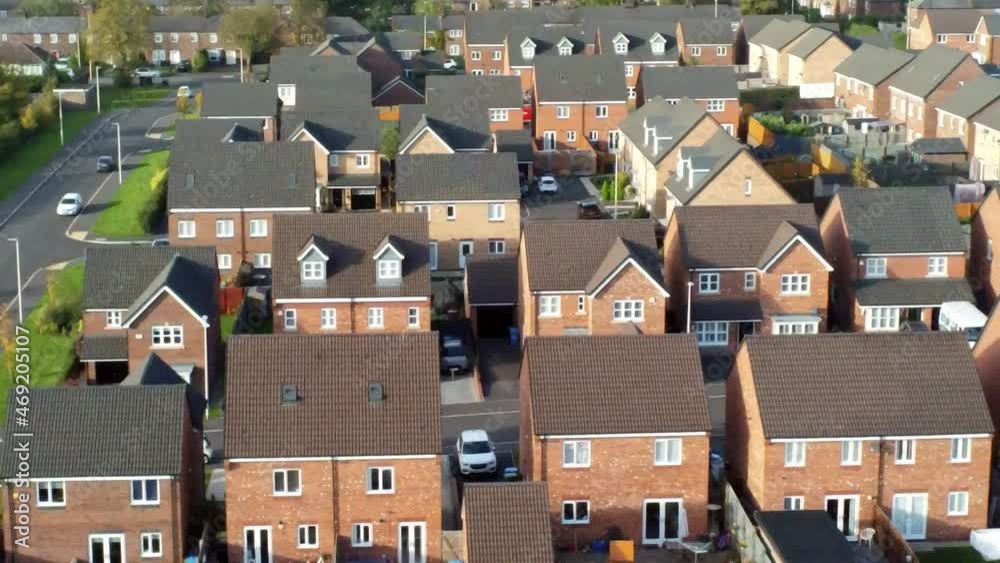 Property ladder new British housing estate aerial view overlooking rooftops slow dolly right shot Property ladder new British housing estate aerial view overlooking rooftops slow dolly right shot