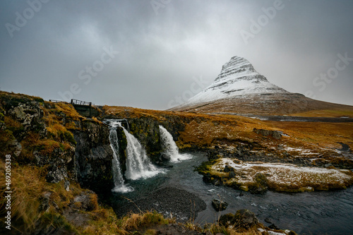 Kirkjufell mountain in Iceland sits covered in snow.