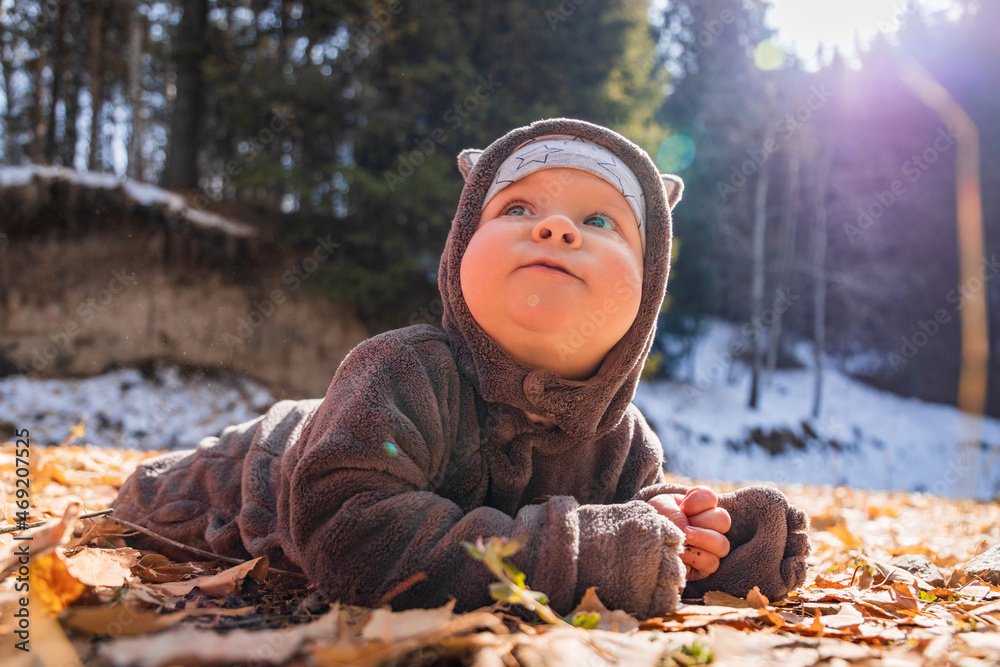 Little smiling baby boy playing in yellow foliage. Autumn in the city park Little smiling baby boy playing in yellow foliage. Autumn in the city park