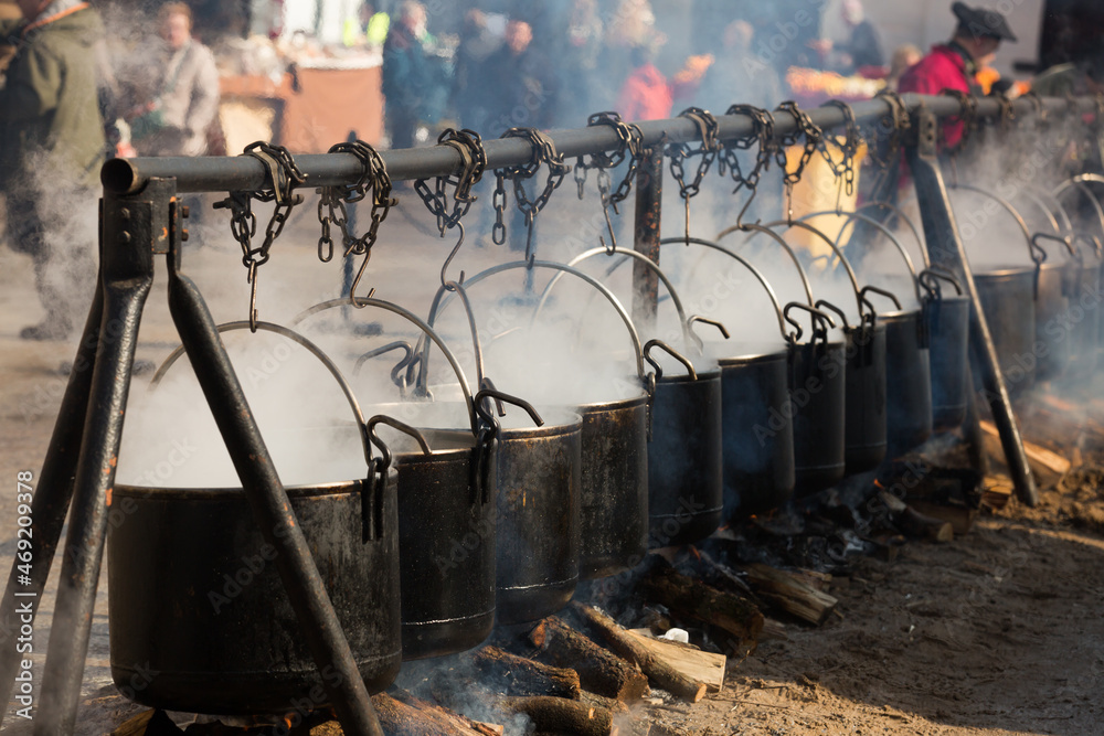 Preparation of food in bowlers on bonfire, cooking outdoor in a traditional style, Spain