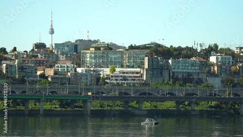 The Hangang River and Namsan Tower in Seoul, South Korea with traffic motion and north city skyline photo