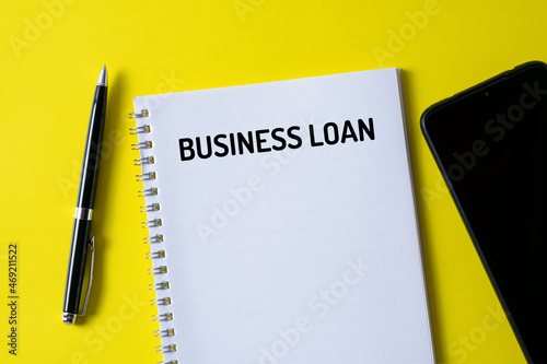  BUSINESS LOAN written in a notebook - business concept.