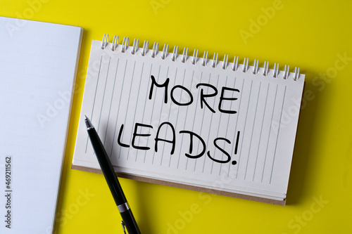 Word writing text MORE LEADS! in a notebook. Business concept.