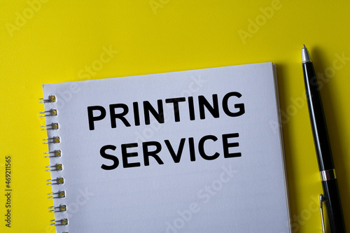 PRINTING SERVICE written in a notebook on yellow background with pen