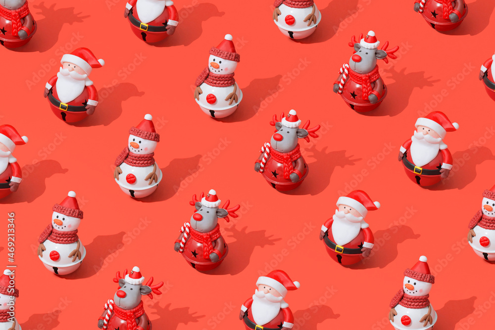 Pattern composition of Christmas toys on red background with hard shadows