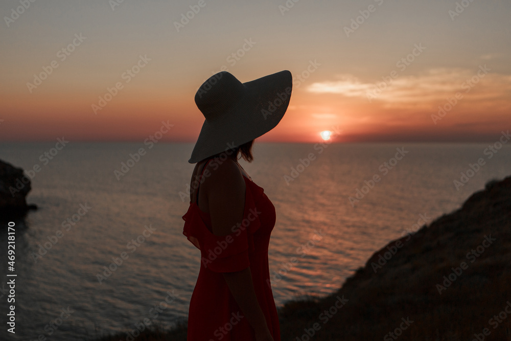 journey to the sea. a girl in a dress and hat is walking along the beach. a tourist walks along the sea coast. hot trips during the holiday period. copy space