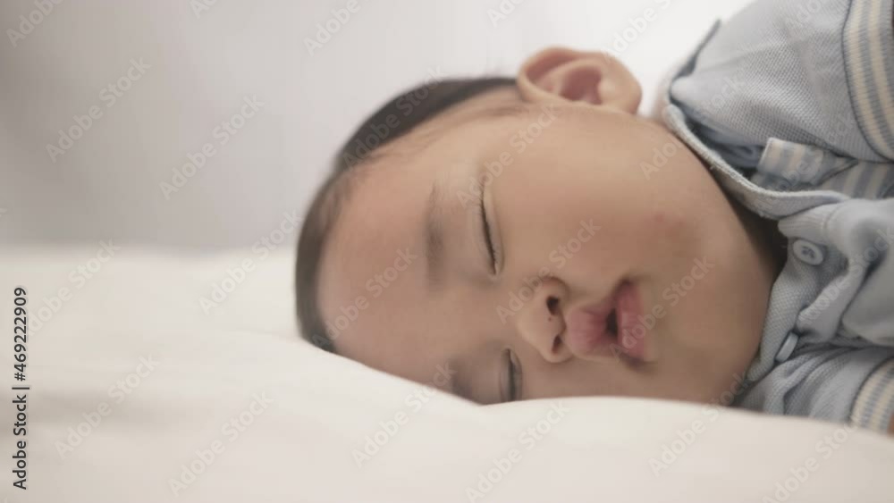 Close up Of Baby Boy Lying And Sleeping Comfortably In The Bed. Close up Of Baby Boy Lying And Sleeping Comfortably In The Bed.