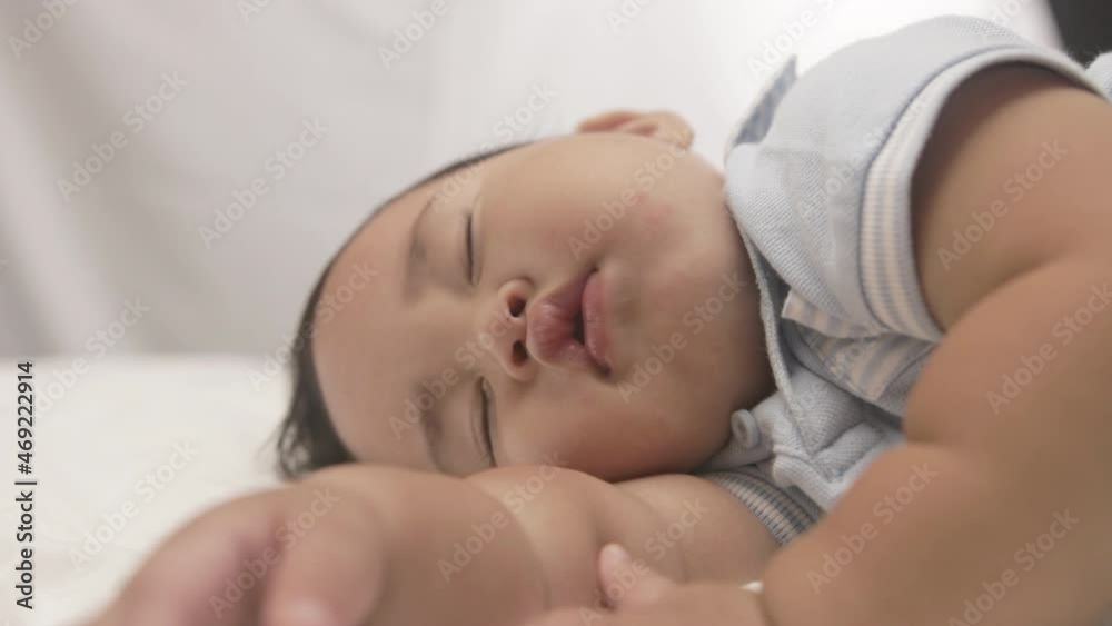 Chubby Baby Boy Peacefully Sleeping On The Bed. - close up Chubby Baby Boy Peacefully Sleeping On The Bed. - close up