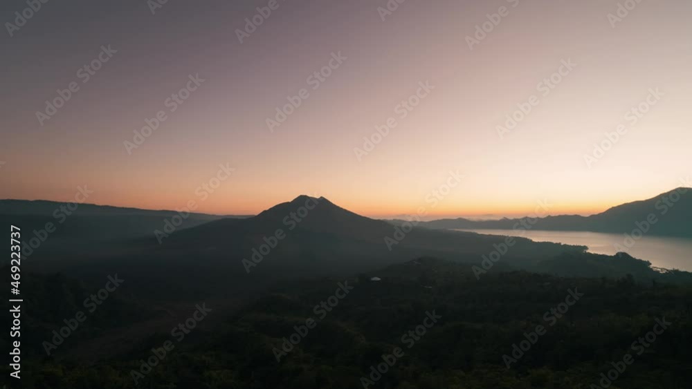 static timelapse of the sunrise over a forest and vulcano at Kintamani, Bali Indonesia 4k.