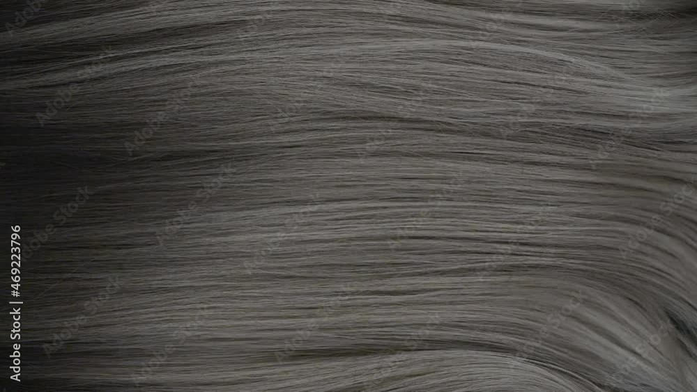 Slow motion waves of beautiful long smooth grey hair texture, haircare concept Slow motion waves of beautiful long smooth grey hair texture, haircare concept