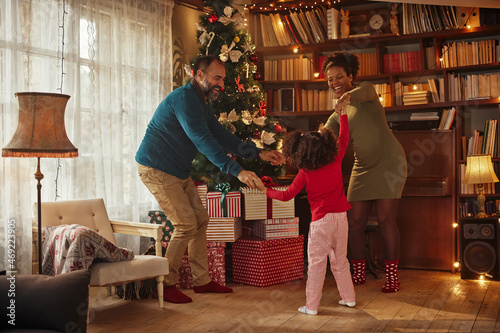 Mixed race family celebrating Christmas at home