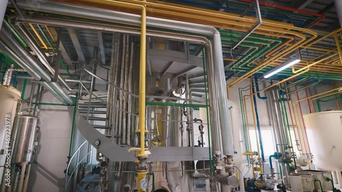 Shop of an industrial enterprise for the production of sunflower oil. The process of product refining takes place in special containers. photo