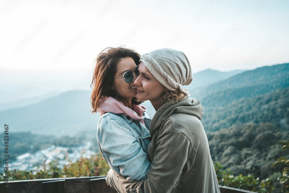 Two women hugging at viewpoint Two women hugging at viewpoint