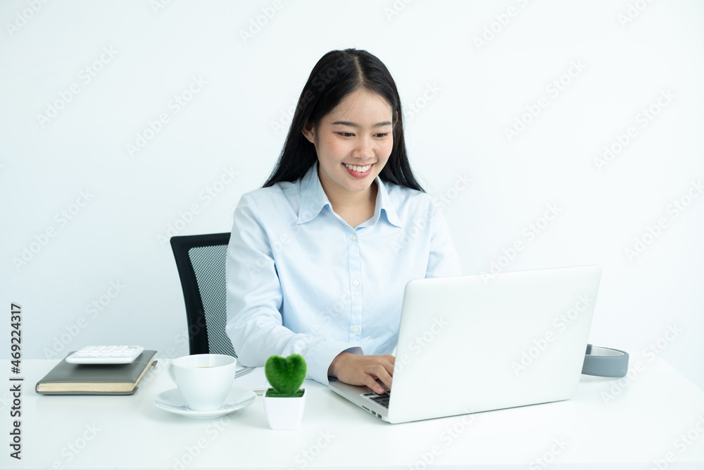 Asian woman working laptop. Successful smiling businesswoman sitting working at the office Asian woman working laptop. Successful smiling businesswoman sitting working at the office