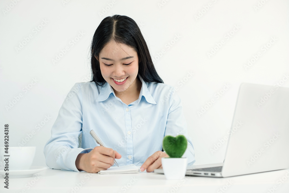 Asian woman working laptop. Successful smiling businesswoman sitting working and take note at the office Asian woman working laptop. Successful smiling businesswoman sitting working and take note at the office