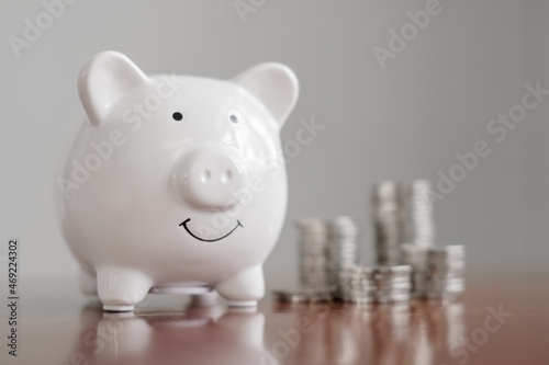piggy bank with golden coins pile, step up growing business to success, and saving for retirement concept