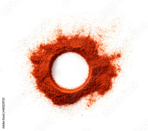 A round frame made of red pepper powder on a white background.