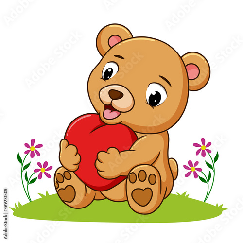 The happy bear hugging the heart doll