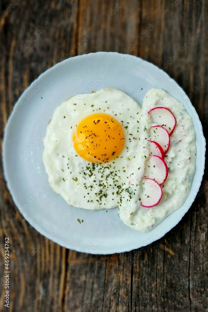 Breakfast in the morning with fried egg and tzatziki Breakfast in the morning with fried egg and tzatziki