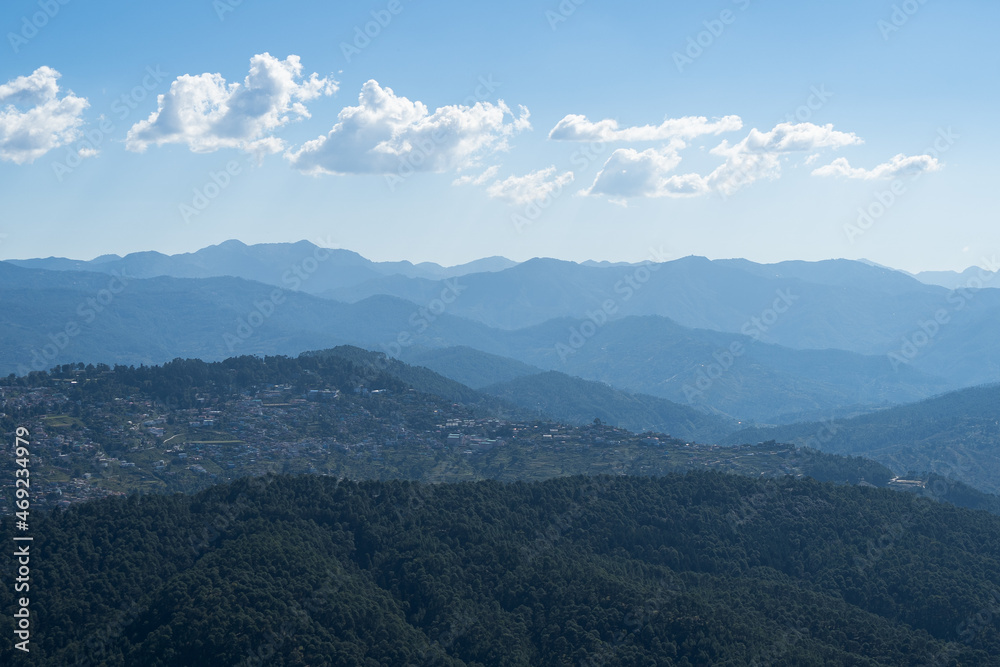view of almora city from kesar devi on a bright sunny day