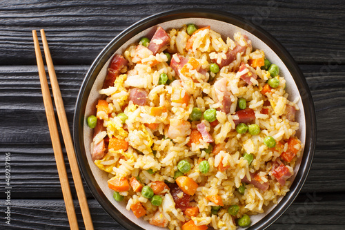 Chinese Egg Fried Rice Yang Chow Fried Rice close up in the plate on the table. Horizontal top view from above photo