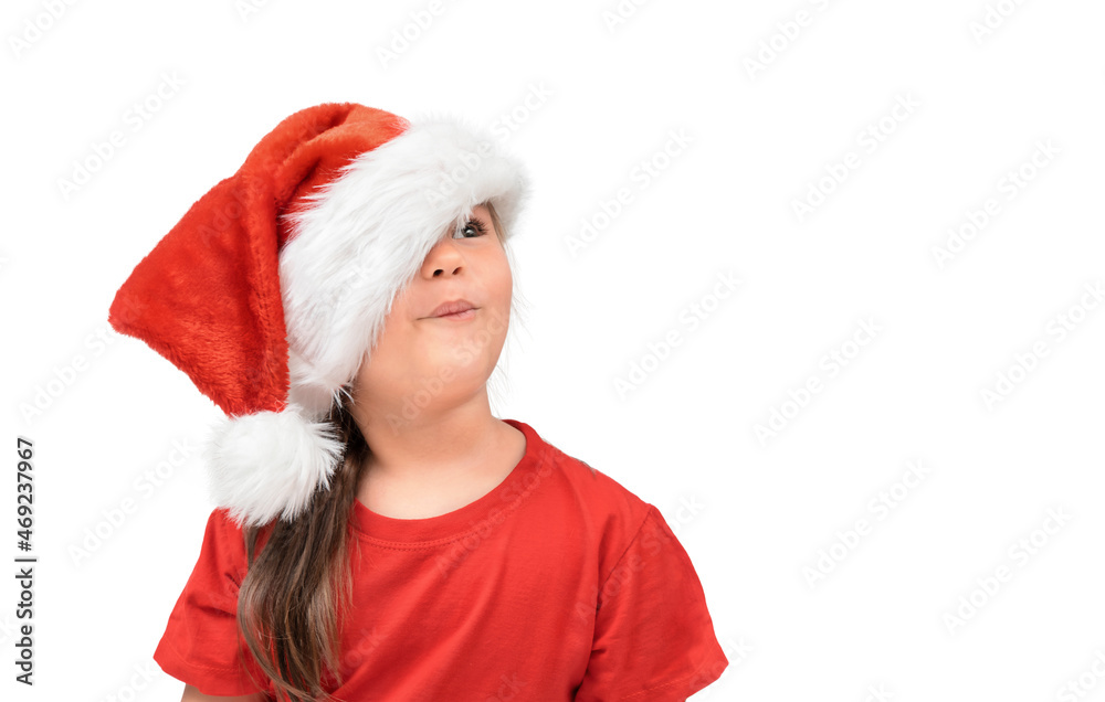 Christmas portrait child girl in santa hat looking with surprise at copy space isolated Christmas portrait child girl in santa hat looking with surprise at copy space isolated