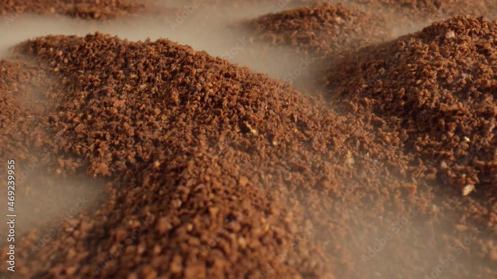Macro shot of aromatic coffee of medium grinding is shrouded in light smoke. Oriental coffee. The concept of making coffee. Rich taste and aroma. High quality. 4k footage. Macro shot of aromatic coffee of medium grinding is shrouded in light smoke. Oriental coffee. The concept of making coffee. Rich taste and aroma. High quality. 4k footage.