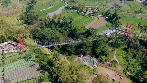 Iconic bridge of Jokowi in Muntilan, surrounded by tropical landscape, aerial drone view photo