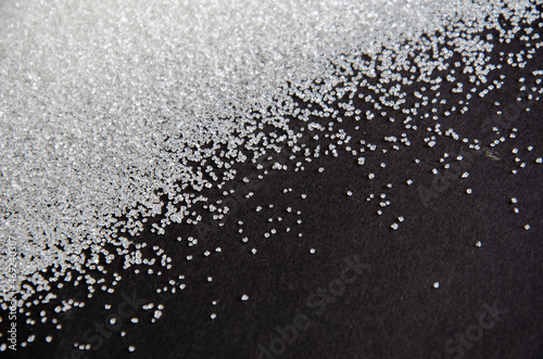 sugar on a black background. sugar crystals close up. Black background. granulated sugar.