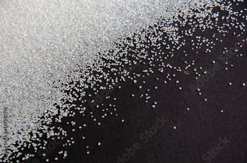 sugar on a black background. sugar crystals close up. Black background. granulated sugar.