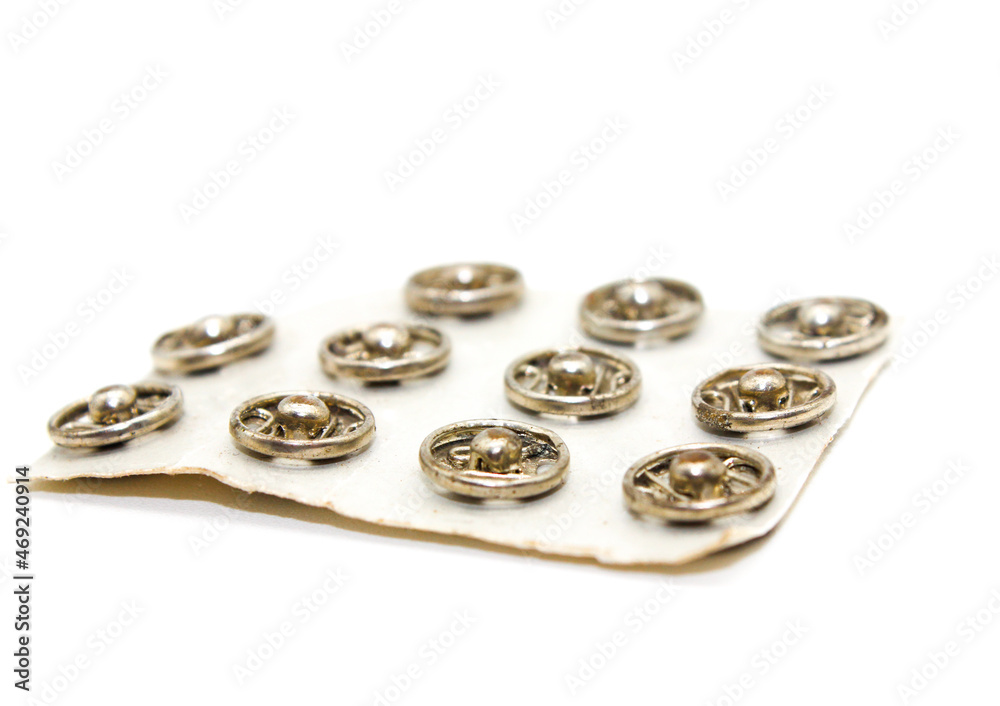 Steel buttons on white background with selective focus