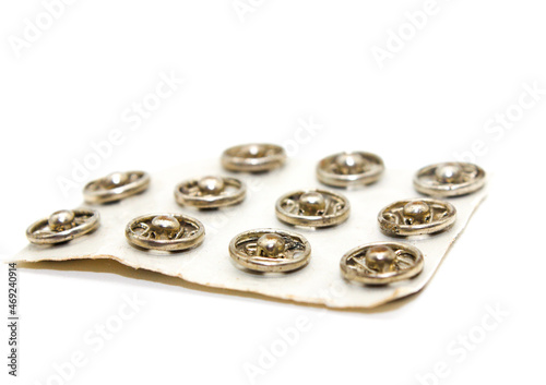 Steel buttons on white background with selective focus