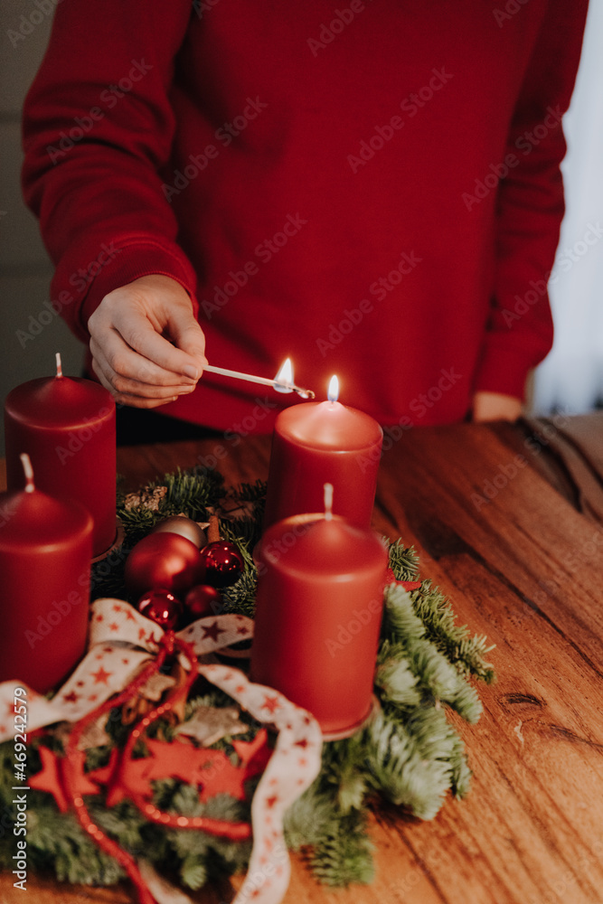Lighting the first candle of Advent Wreath on the first Advent Sunday counting four weeks till