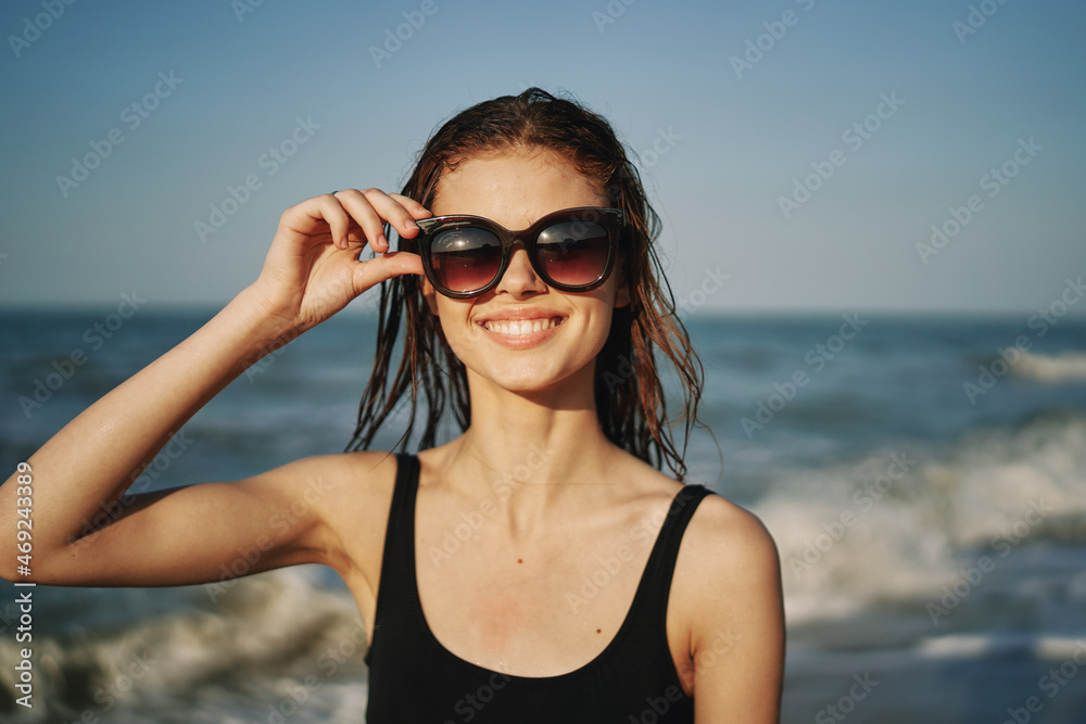 cheerful woman in black swimsuit sunglasses ocean travel cheerful woman in black swimsuit sunglasses ocean travel