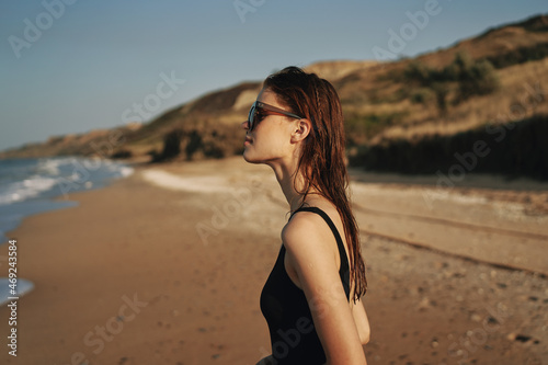 pretty woman in black swimsuit beach nature sun
