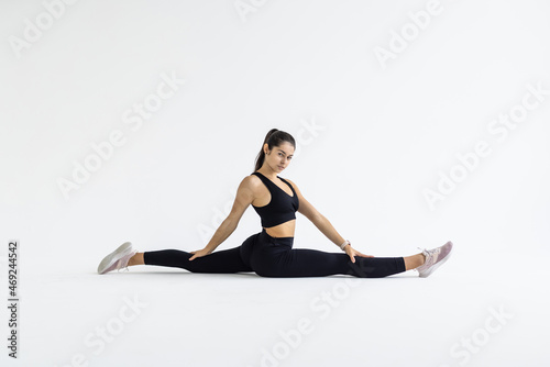 sport fitness woman, young healthy girl doing stretching exercises over white background