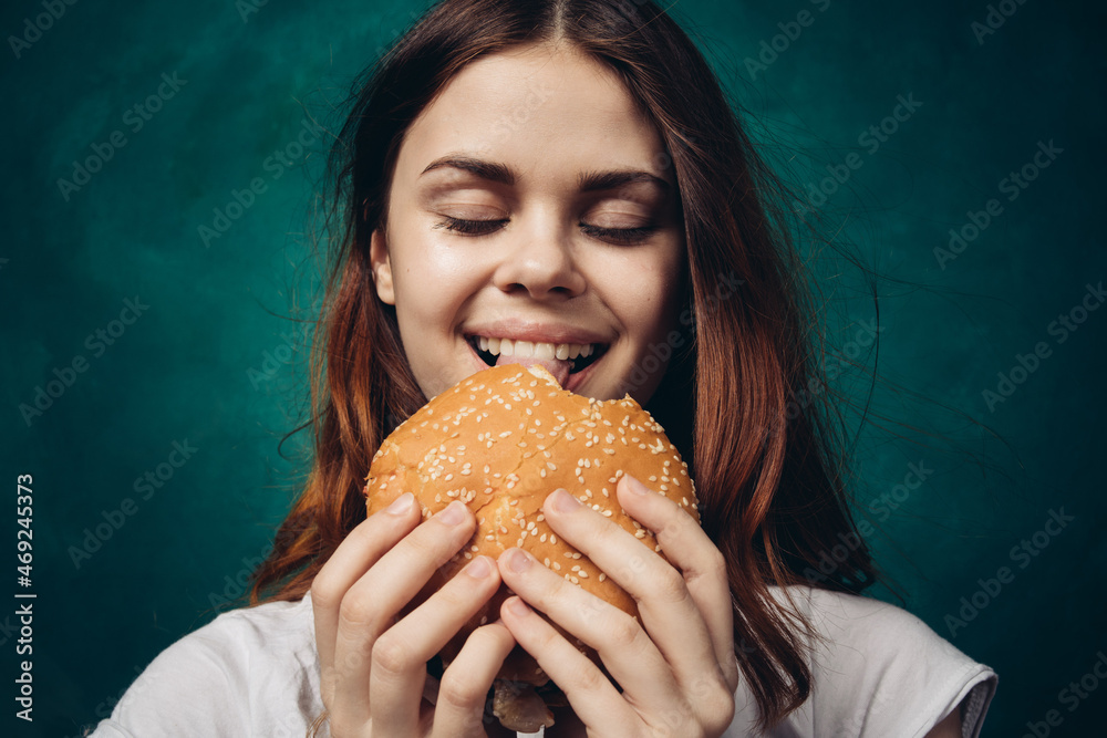 woman eating hamburger fast food snack close-up woman eating hamburger fast food snack close-up