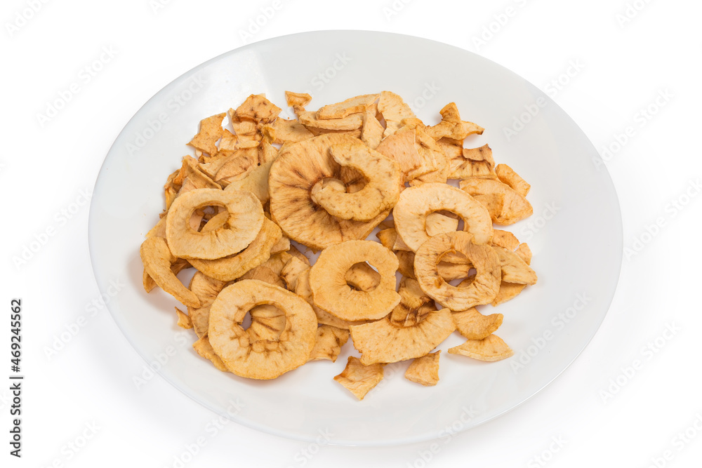 Pile of apple chips on white dish on white background