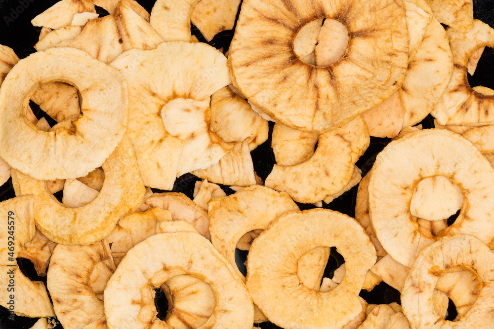 Background of the apple chips pile on the black dish