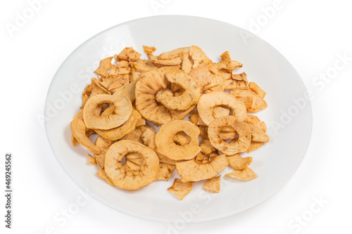Pile of apple chips on white dish on white background