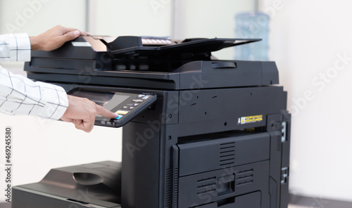 Bussinessman press button on panel of printer photocopier network , Working on photocopies in the office concept , printer is office worker tool equipment for scanning and copy paper.