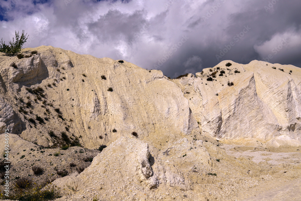 White chalk mountain, quarry against the dark stormy sky